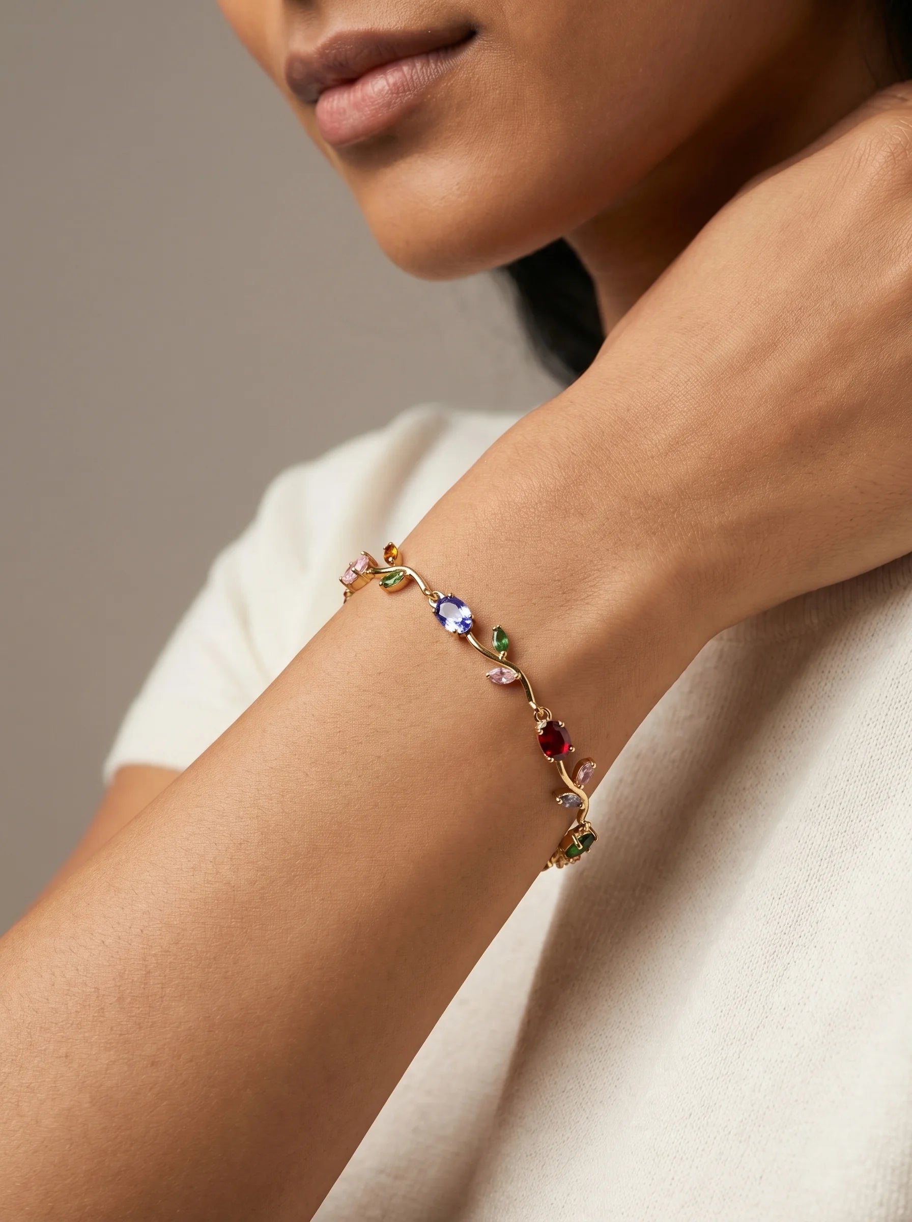 Close-up of Aurum & Isle Flora vine bracelet — gold vine with coloured gemstones, anti-tarnish finish.