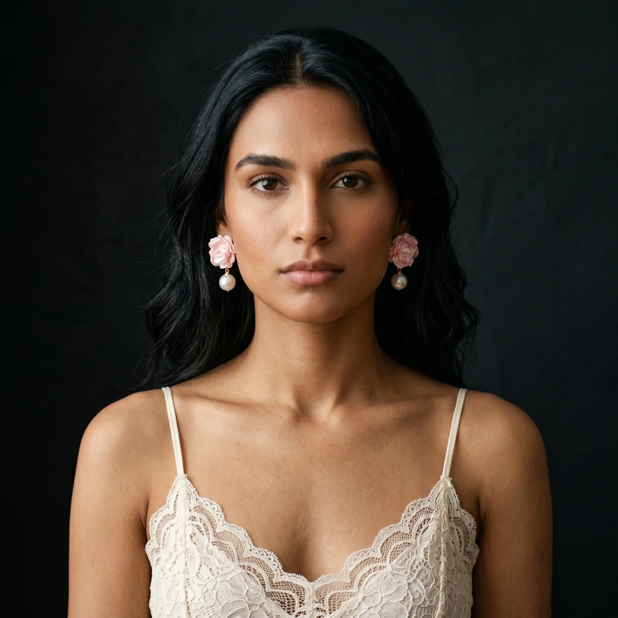 Roza pink pearlescent rose drop earrings worn front-facing with cream lace cami