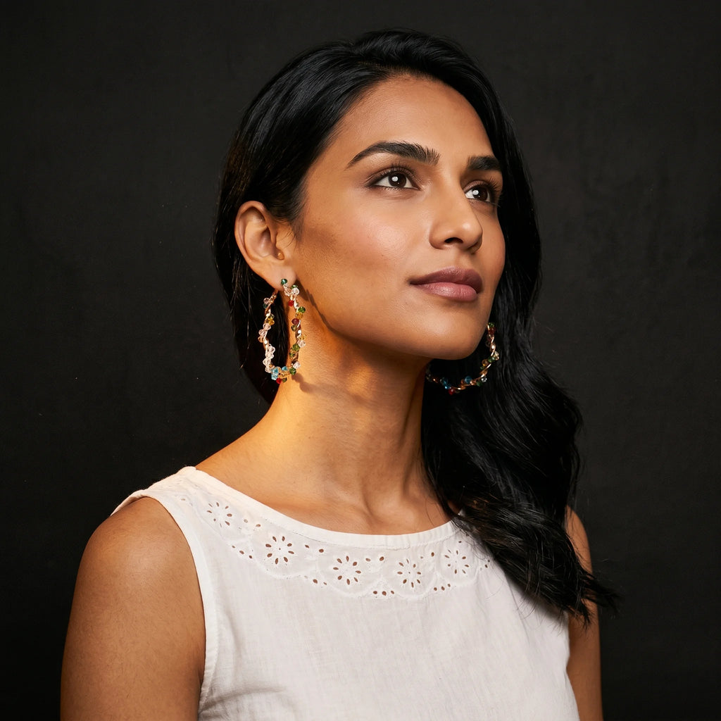 Aria multicolour crystal hoops worn with white eyelet top — editorial portrait
