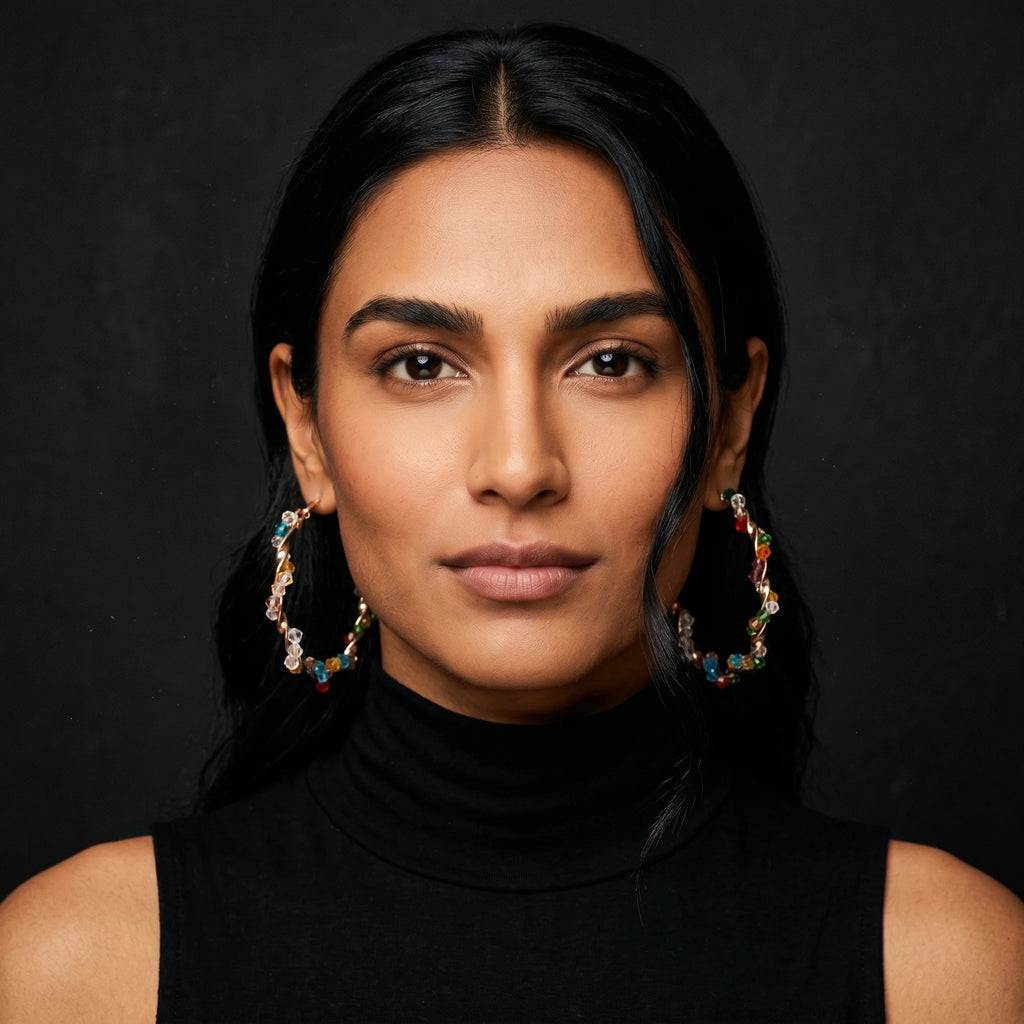 Aria twisted gold hoops with multicolour crystal beads worn front-facing with black turtleneck