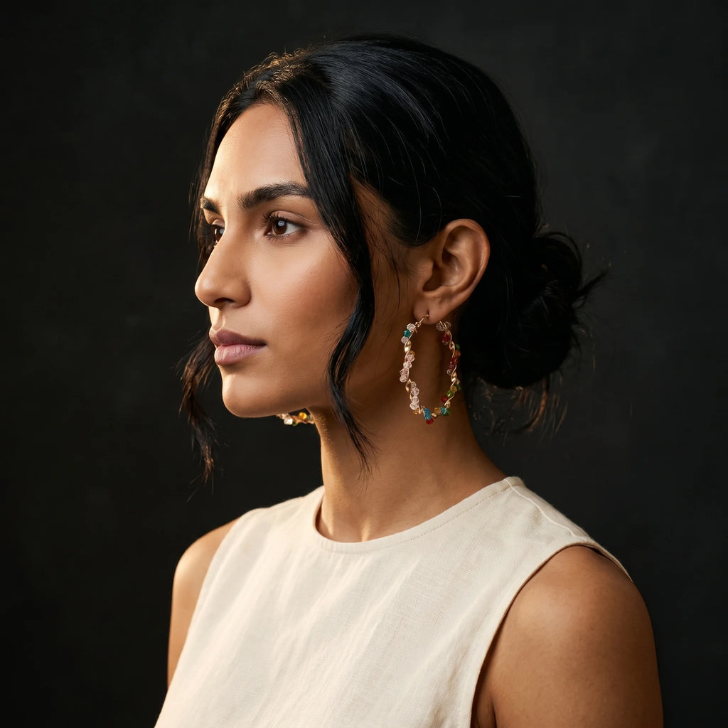 Aria twisted gold hoop with jewel-tone bicone beads — side profile with cream tank