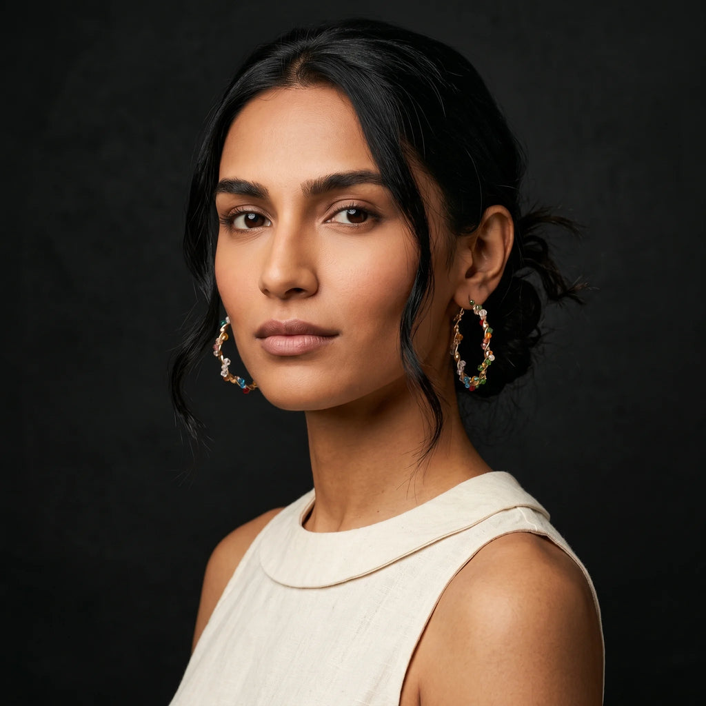 Aria multicolour crystal bead gold hoops worn with cream tank — three-quarter turn