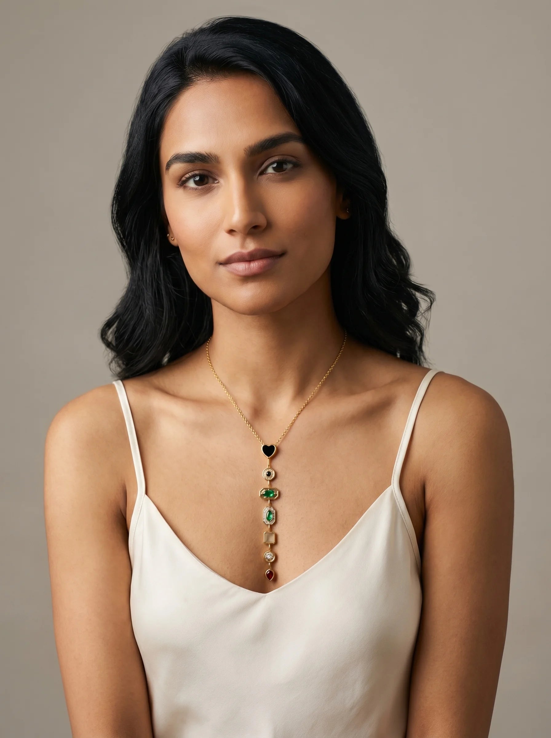 Aurum & Isle Éclat Y-drop gold necklace paired with cream slip dress — layered gemstone pendant.