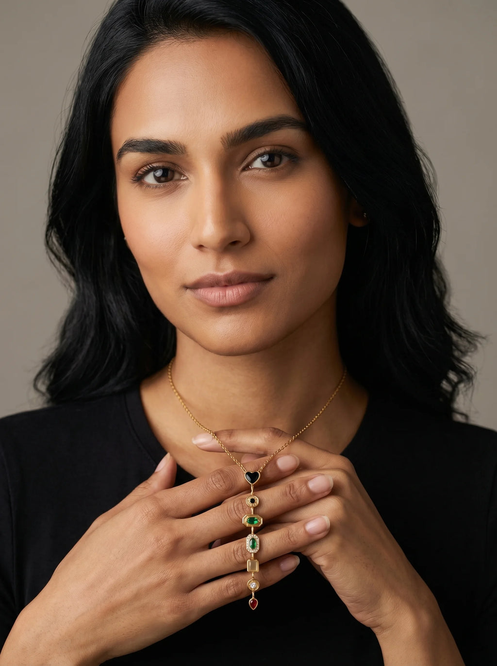 Model wearing Aurum & Isle Éclat Y-drop gold necklace with heart, emerald and ruby stones — anti-tarnish.