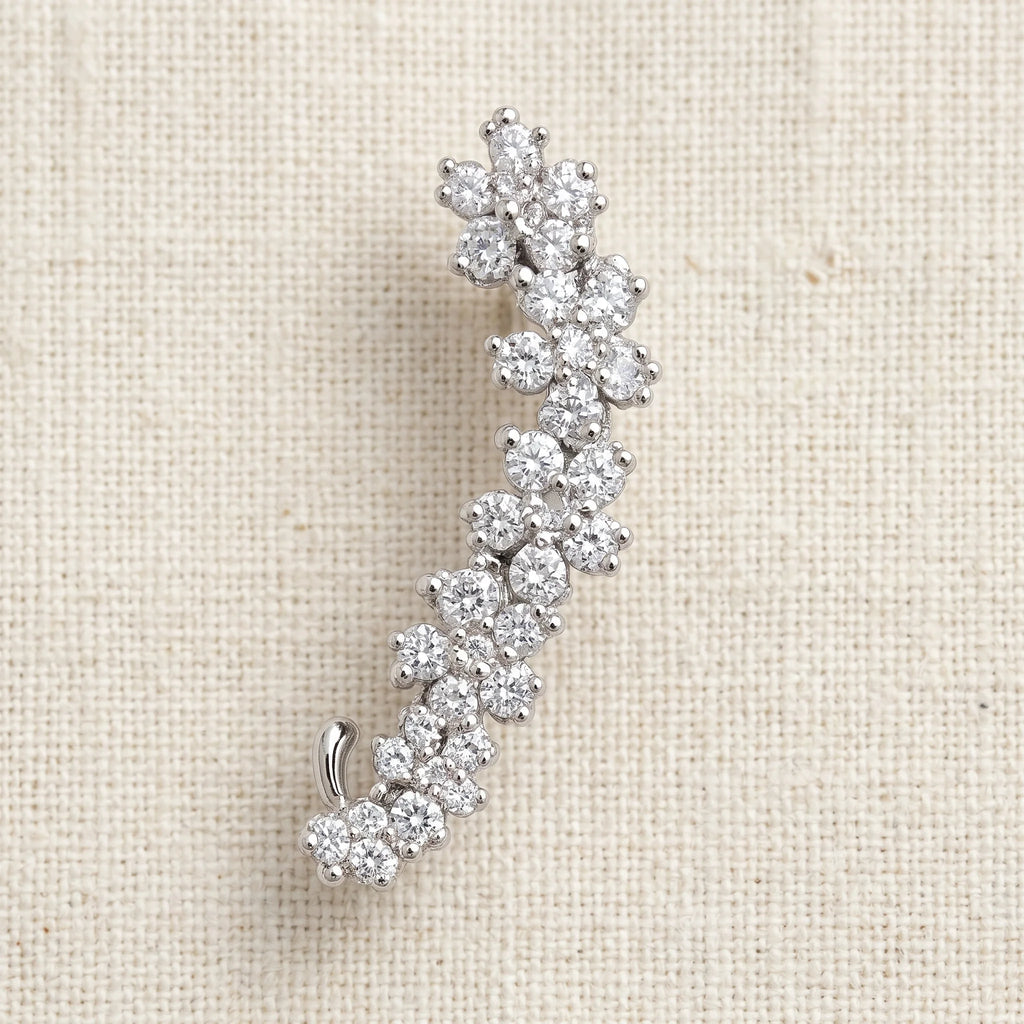 Indu silver curved ear climber with rhinestone floret clusters on cream linen — Aurum & Isle