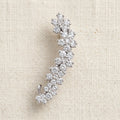 Indu silver curved ear climber with rhinestone floret clusters on cream linen — Aurum & Isle