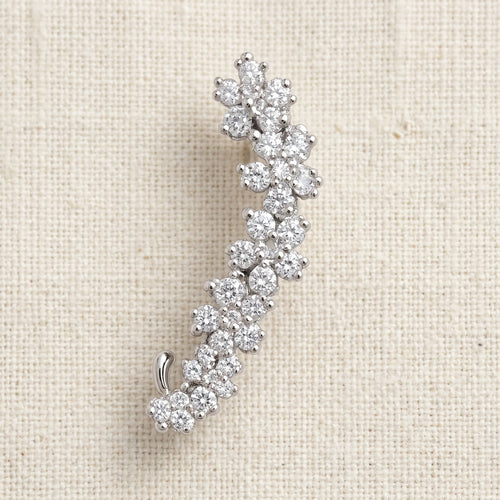 Indu silver curved ear climber with rhinestone floret clusters on cream linen — Aurum & Isle