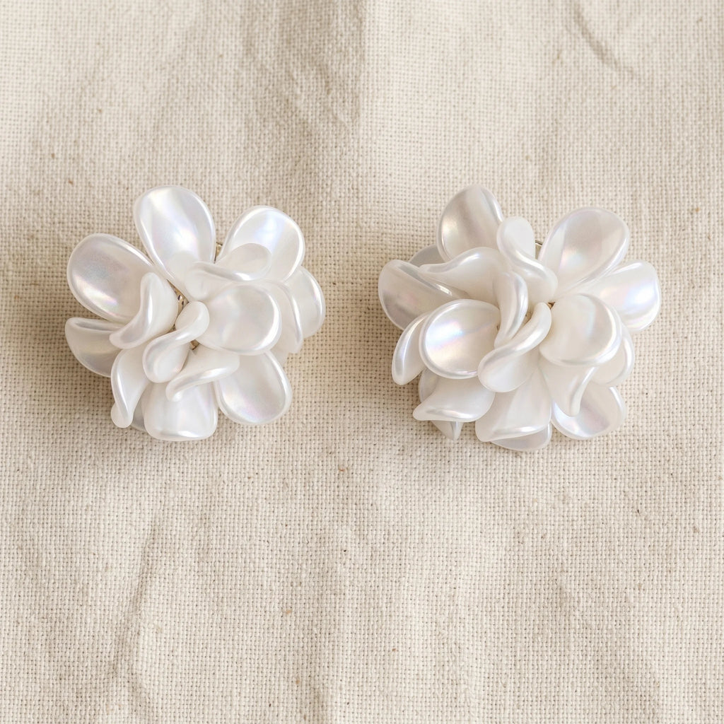 Malati layered pearlescent white flower cluster studs in dimensional bloom silhouette on cream linen — Aurum & Isle