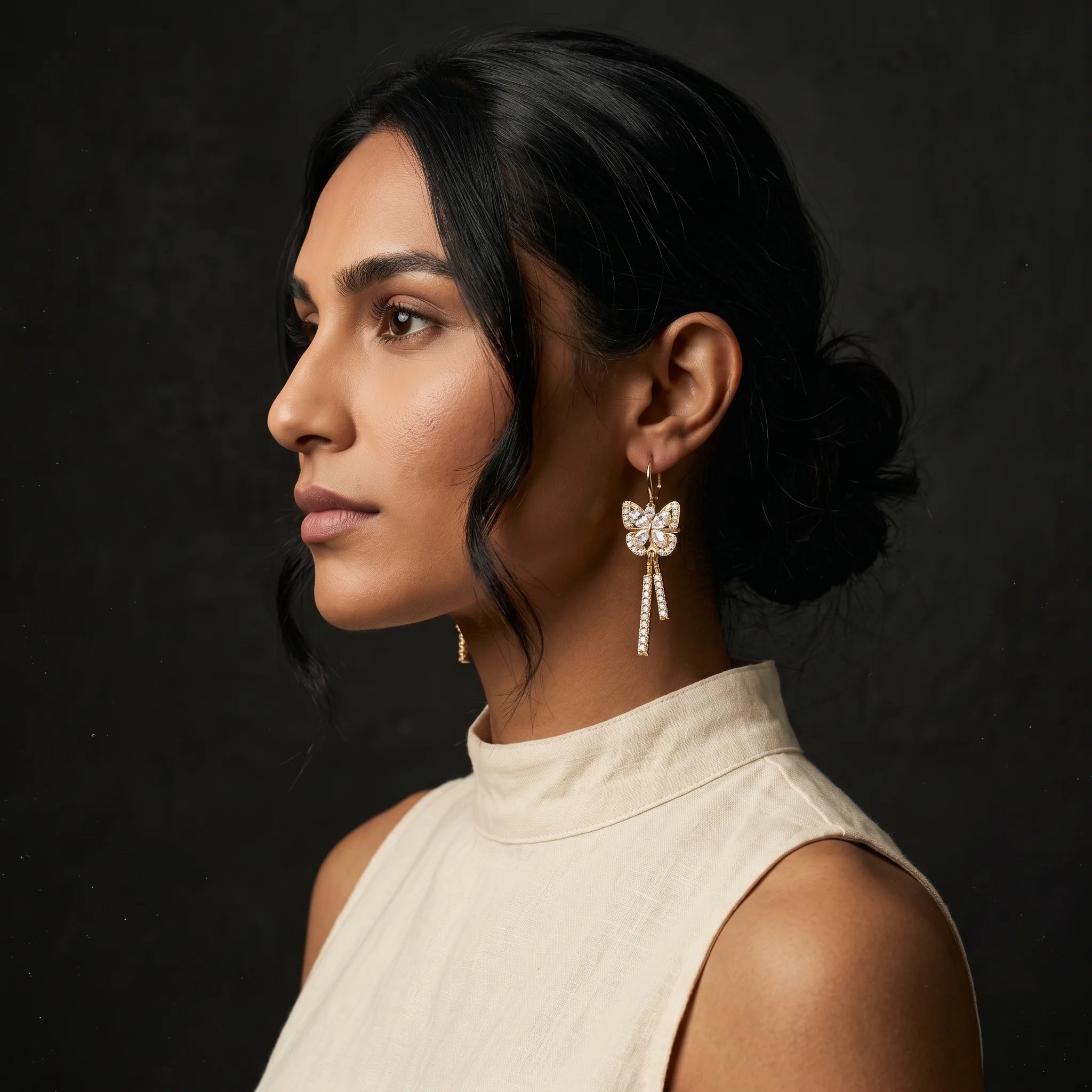 Mira gold butterfly drop earring side profile — pavé tassels falling along the jaw