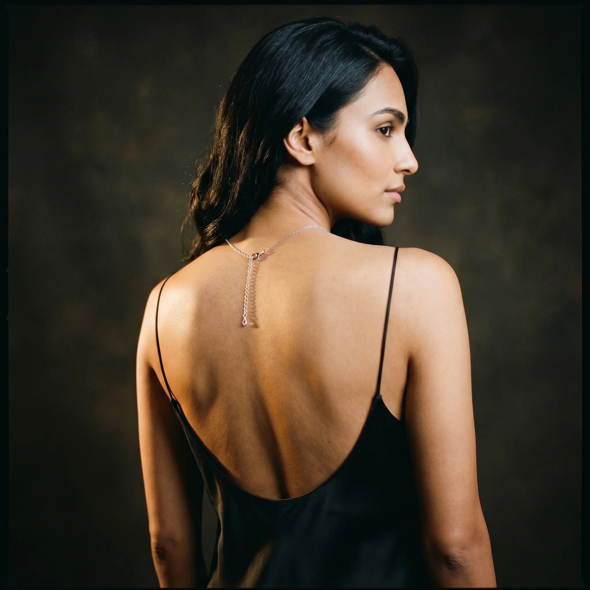 Nira silver Y-necklace lobster-clasp extender at the nape — back over-shoulder view