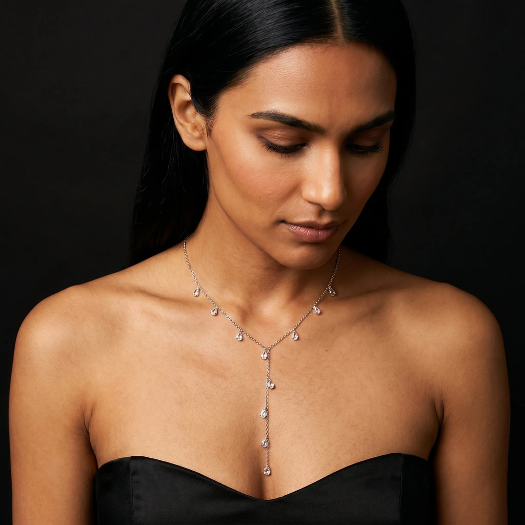 Nira silver CZ teardrop Y-necklace worn on model in black corset — close-up of cascading drop