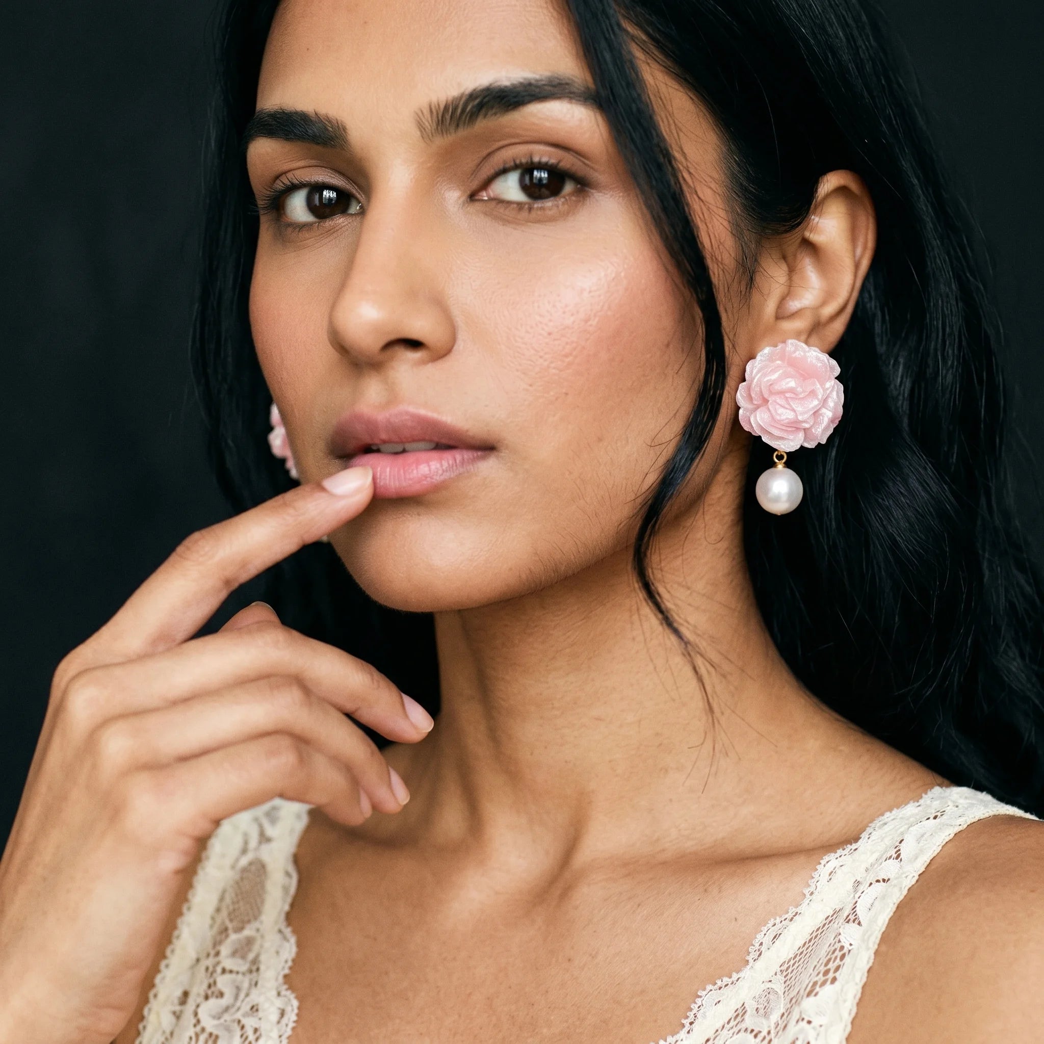 Roza pink rose pearl drop earring worn on model in cream lace cami — close-up with finger at lip