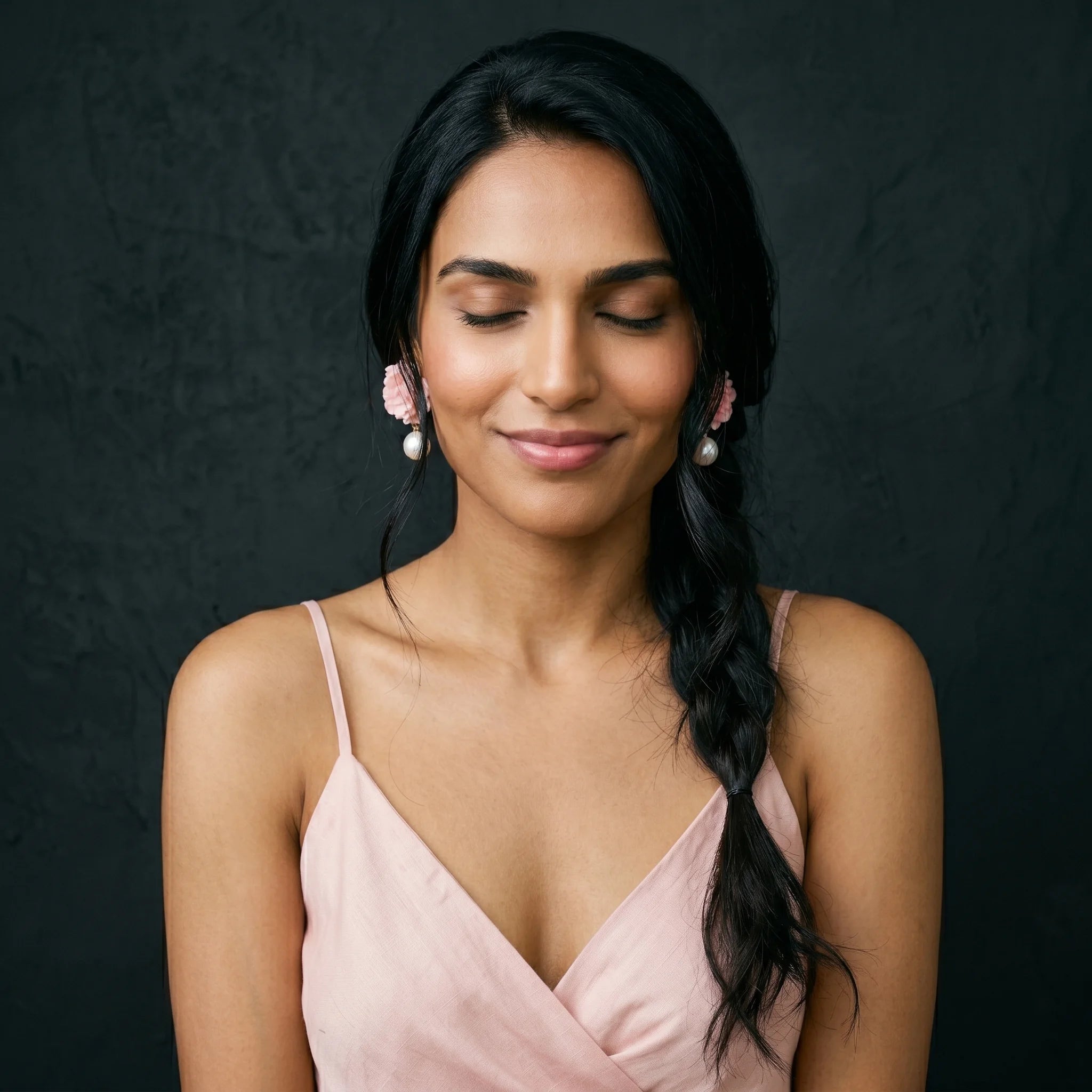 Roza pink rose pearl drops worn with cream pink-floral embroidered top — joyful candid portrait