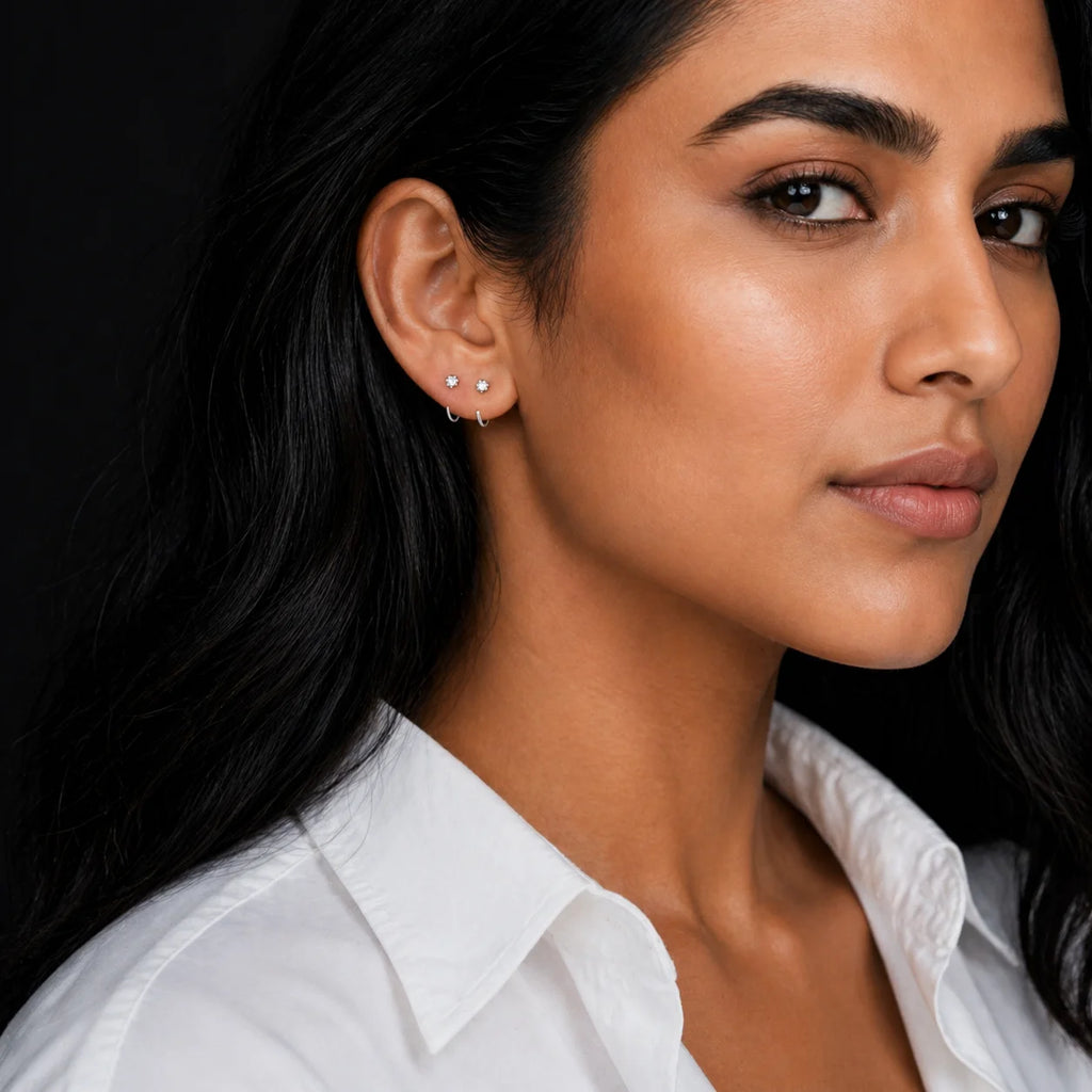 Tara silver CZ stud worn on model with white shirt — ear-stack styling with a smaller silver hoop